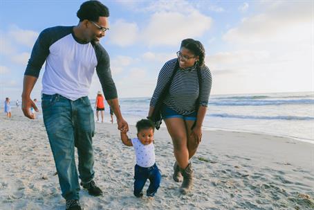 parents at the beach with child