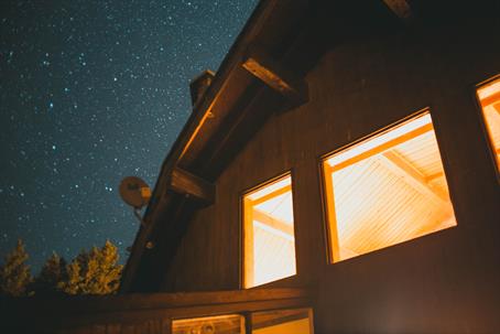 home with lights on at night